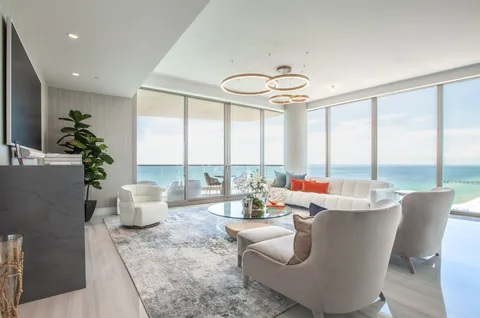An oceanfront condominium interior with floor-to-ceiling windows