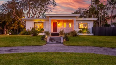 A modest single-story home photographed at dusk